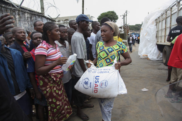 EBOLA QUARANTINE. Liberian residents of West Point receive food rations as part of governments quarantine plan for the area as a way of curbing the spread of the deadly Ebola virus in Monrovia, Liberia, 21 August 2014. Ahmed Jallanzo/EPA