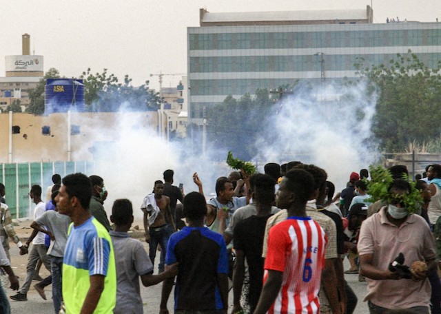 MARCH. Tear gas fumes rise at a mass demonstration of Sudanese protesters against the country's ruling generals in the capital Khartoum's central 'Khartoum 2' district in June 2019. Photo by Ebrahim Hamid / AFP  