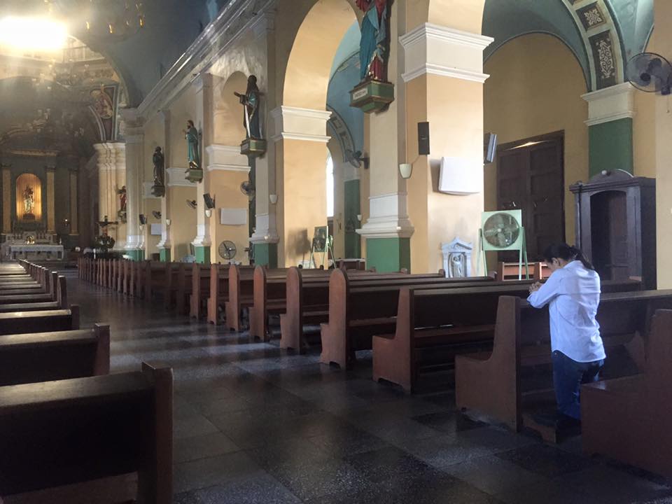 DISQUALIFIED BET. Presidential aspirant Senator Grace Poe lights a candle and says a prayer in Jaro Cathedral in Iloilo, where she was found in 1968. She also meets with the relative of the man who allegedly found her. Photo by Gary Jimenez 