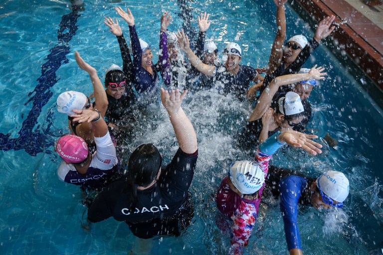 SWIMMERS. Filipina domestic cheering with an instructor during a swimming class provided by the Splash Foundation at a swimming pool in Hong Kong. Photo by Vivek Prakash/AFP  