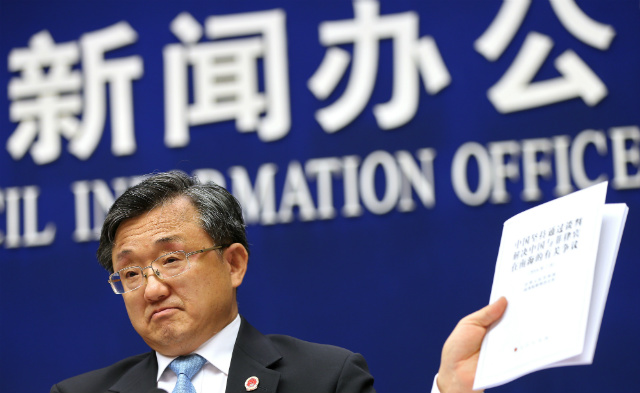 REJECTING THE RULING. Chinese Vice Foreign Minister Liu Zhenmin holds up a policy paper on China's position on the ruling of an arbitral tribunal on the South China Sea during a press conference in Beijing, China, on July 13, 2016. Photo by How Hwee Young/EPA  