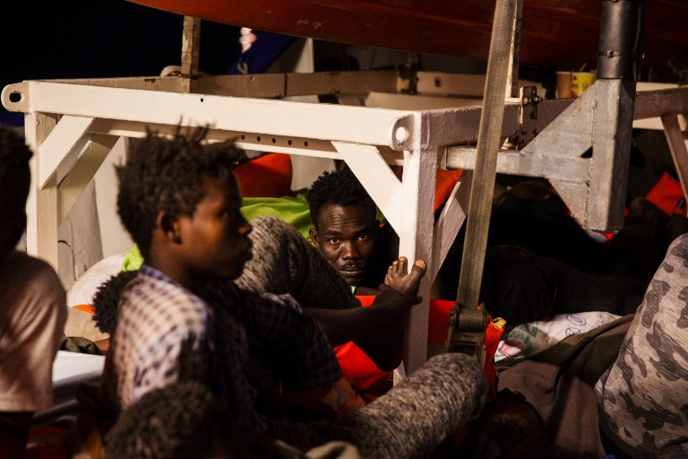 ACCEPTED. This handout picture taken and released June 25, 2018 by German NGO 'Mission Lifeline' off the coast of Malta shows migrants resting on board the Lifeline ship. Photo by Felix Weiss/Mission Lifeline e. V./AFP 