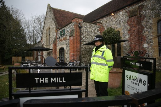 ESPIONAGE. A police officer stand in front of a cordon in front of The Mill pub in Salisbury, southern England, on March 11, 2018, as investigations continue in connection with the major incident sparked after a man and a woman were apparently poisoned in a nerve agent attack a week ago. File photo by Daniel Leal-Olivas/AFP  
