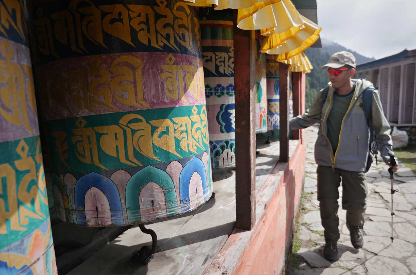 Romi spins the prayer wheels for protection and fortitude for his climb 