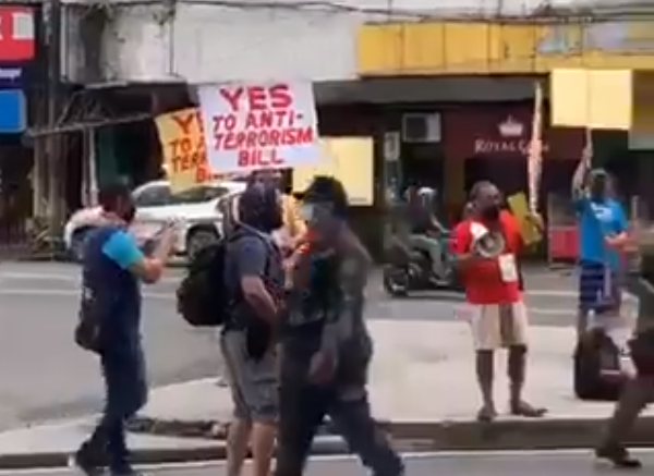 DOUBLE STANDARD. Police personnel were seen taking pictures of anti-terror bill supporters in the same morning police in riot uniforms were stationed in UP Cebu. Screenshot from a video posted by Bayan Central Visayas  