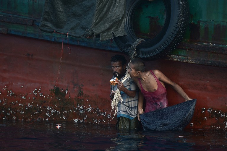 THE UNWANTED. Australia has faced criticism in the past over its policies against asylum seekers arriving by boat. In this photo, a Rohingya migrant eats food dropped by a Thai army helicopter on May 14, 2015. File photo by Christophe Archambault/AFP  
