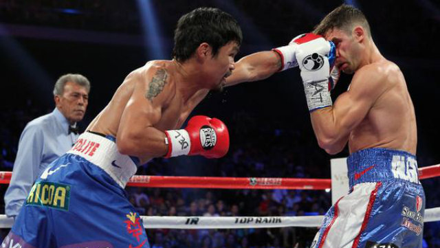 Manny Pacquaio lands a straight left onto Chris Algieri's face. Photo by Chris Farina/Top Rank