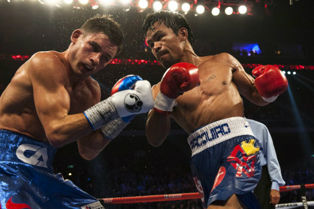 FIGHT SHORTS. Manny Pacquiao, seen here during his most recent bout vs Chris Algieri, will earn an extra $2 million for his fight shorts. Photo by AFP 