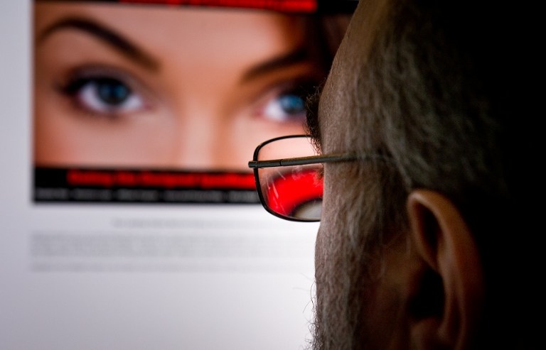 ‘NO SECURITY.’ A file picture taken on February 10, 2014 shows a man as he looks at a dating site on his computer in Washington, DC. Photo by Eva Hamback / AFP 