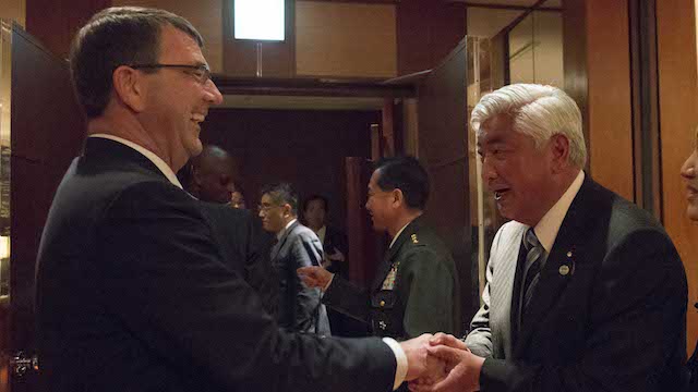 JAPAN VISIT. US Defense Secretary Ash Carter gives a challenge coin to Japanese Defense Minister General Nakatani after a dinner hosted by Nakatani at the Park Hyatt Hotel in Tokyo, April 8, 2015. Pentagon photo   