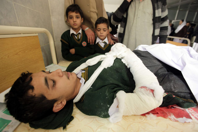 INJURED STUDENT. A school boy who was injured in a Taliban attack receives medical treatment at a hospital in Peshawar, Pakistan, 16 December 2014. Photo by Arshad Arbab/EPA