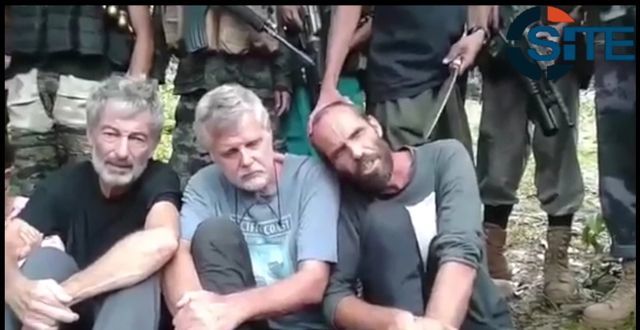 HOSTAGES. The Abu Sayyaf shows 3 foreigners it held hostage. Screenshot of file video from SITE Intelligence Group 