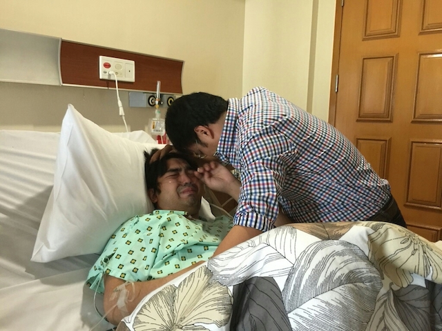 HOSPITAL VISIT. Detained senator Ramon 'Bong' Revilla Jr makes an emotional visit to son Jolo, who is confined at the hospital for a gunshot wound, on March 3, 2015. Photo courtesy of the office of Senator Revilla  