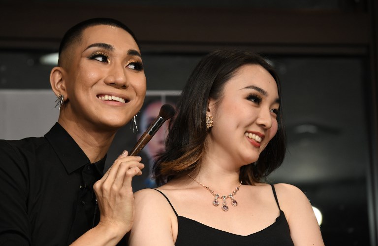 LGBT MONK. In this photo taken on July 19, 2018 Japanese make-up artist and Buddhist monk Kodo Nishimura (left) poses with model Yuri Hotta during the talk session at the Waseda University in Tokyo. 
Photo by Toshifumi Kitamura/AFP  