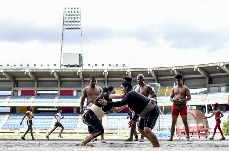 UNDERWEIGHT. Venezuelan female sumo wrestlers train at the Brigido Iriarte stadium in Caracas. Photo by Juan Barreto/AFP  