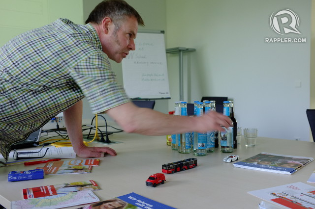 TEACHING COMMUTERS. Christoph Unland of the HVV School Advisory Service says teachers use simple props like car toys to teach students about safety when commuting  
