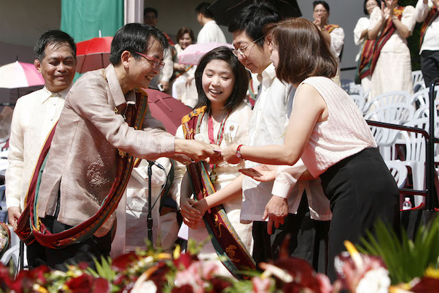 SUMMA CUM LAUDE. University of the Philippines chancellor Micheal Tan congratulates the parents of Biology major Tiffany Grace Uy during the university graduation at the Ampitheater of the UP Diliman campus in Quezon City on Sunday, June 28. Photo by Ben Nabong   
