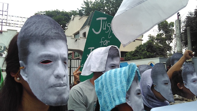 MASKED PROTESTERS. Protesters wearing Jonas Burgos masks gather at the gate of Camp Aguinaldo to commemorate his disappearance. File photo from Desaparecidos 