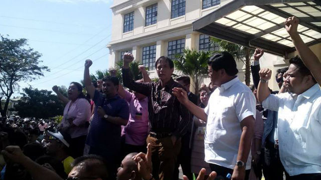 SUSPENSION. Cebu City Mayor Michael Rama and Vice Mayor Edgar Labella address city hall members during a morning flag raising ceremony after Malacañang announced they were suspending the mayor, vice mayor and 12 city councilors over the distribution of calamity funds to city hall employees in 2013. File photo by Rappler
  