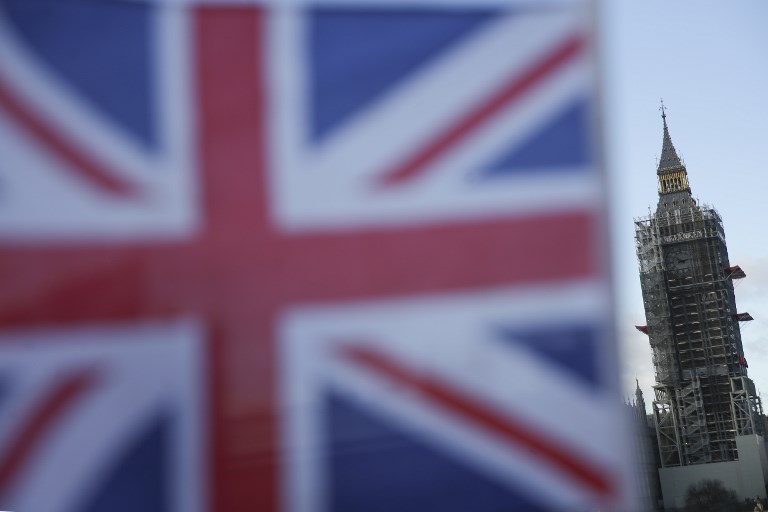 BREXIT. A Union Flag is seen with Elizabeth Tower (Big Ben) shrouded in scaffolding in the background at the Houses of Parliament in London on December 8, 2017 after a significant breakthrough was made in the divorce negotiations between Britain and the EU over Brexit. File photo by Daniel Leal-Olivas/AFP 