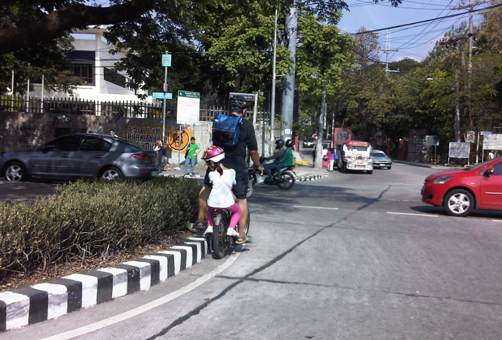 ROAD SAFETY. Father and daughter biking along Katipunan Avenue in Quezon City. Photo by Jose Regin F. Regidor  