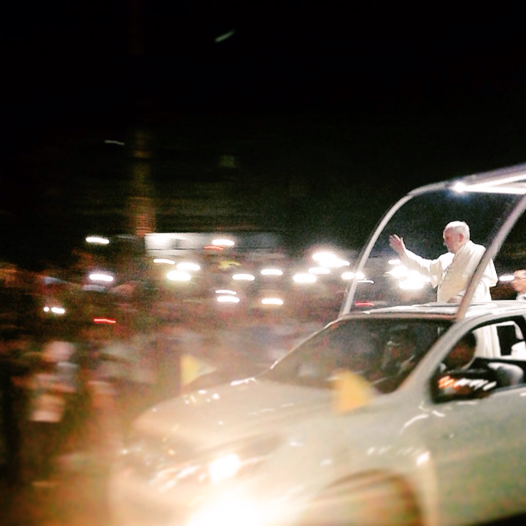 Pope Francis waves to the crowds during his arrival in Manila