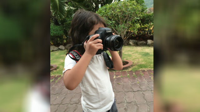 LET HER TRY. Aki taking photos with her dad's camera.  