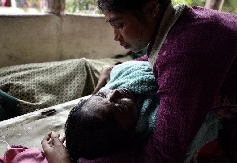 TOXIC. An Indian woman mourns over the dead body of her mother who died after drinking toxic bootleg liquor, at Kushal Konwar Civil Hospital in Golaghat district in the northeastern Indian state of Assam on February 23, 2019. Photo by David Talukdar/AFP 
