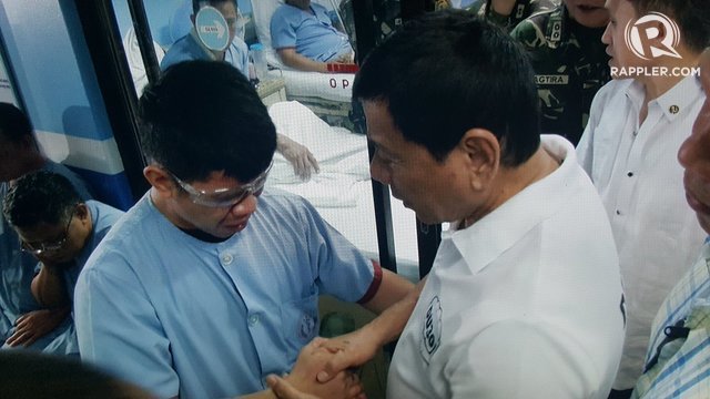 CONCERN. President Duterte salutes then hugs blind soldier Jerome Jacuba at the AFP Medical Center on August 2, 2016. Photo by Pia Ranada/Rappler 