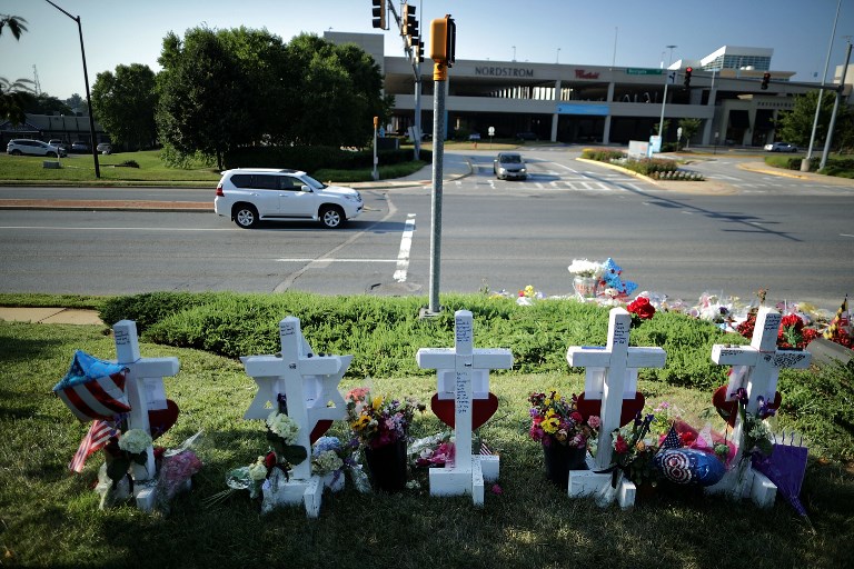 MEMORIAL. Five wood markers stand in a makeshift memorial outside the Annapolis Capital Gazette offices for the employees killed by a gunman July 2, 2018 in Annapolis, Maryland. File Photo by Chip Somodevilla/Getty Images/AFP   