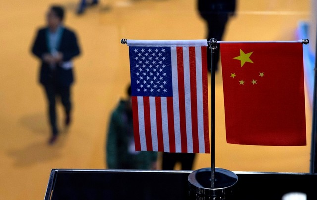 TRADE WAR. This file picture taken on November 6, 2018, shows a Chinese and US flags at a booth during the first China International Import Expo (CIIE) in Shanghai. File photo by Johannes Eisele/AFP 
