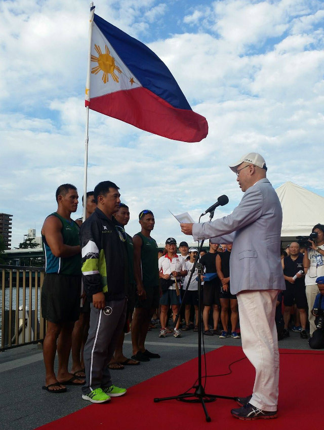 The Philippine flag waves in Osaka, Japan as members of the Army team accept their gold medals. Photo by Philippine Army Dragon Boat team  