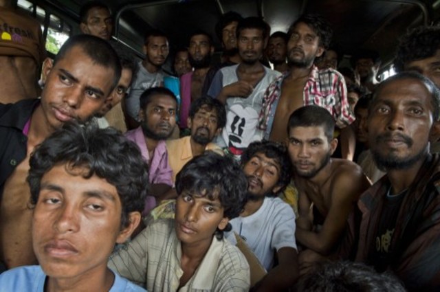 INFLUX. In this photograph taken on May 20, 2015, Bangladeshi migrants are transported on a bus in Langsa, Aceh province after they were rescued by Indonesian fishermen off the eastern coast of Aceh. AFP File photo 