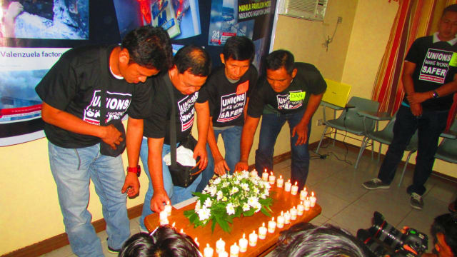 REMEMBERING. Union workers light candles to remember their colleagues who died or got injured due to work accidents. Photo from Alan Tanjusay's Facebook page 