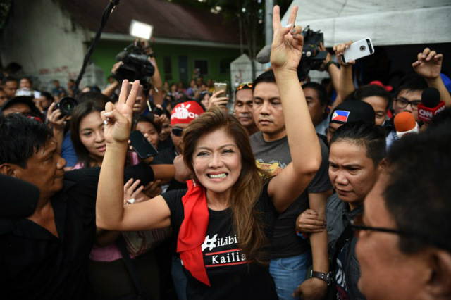 'VICTORY.' Imee Marcos (C), daughter of the late dictator Ferdinand Marcos, flashes the 'V' sign as she celebrates with supporters on November 8, 2016, after the Supreme Court allowed a hero's burial for her father. Photo by Ted Aljibe/AFP  
