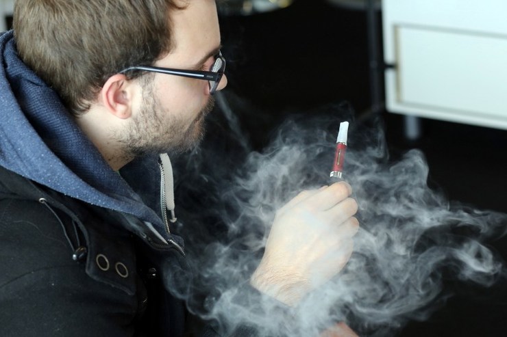 A man smokes an e-cigarette in Bordeaux, western France, on March 13, 2014. Nicolas Tucat/AFP