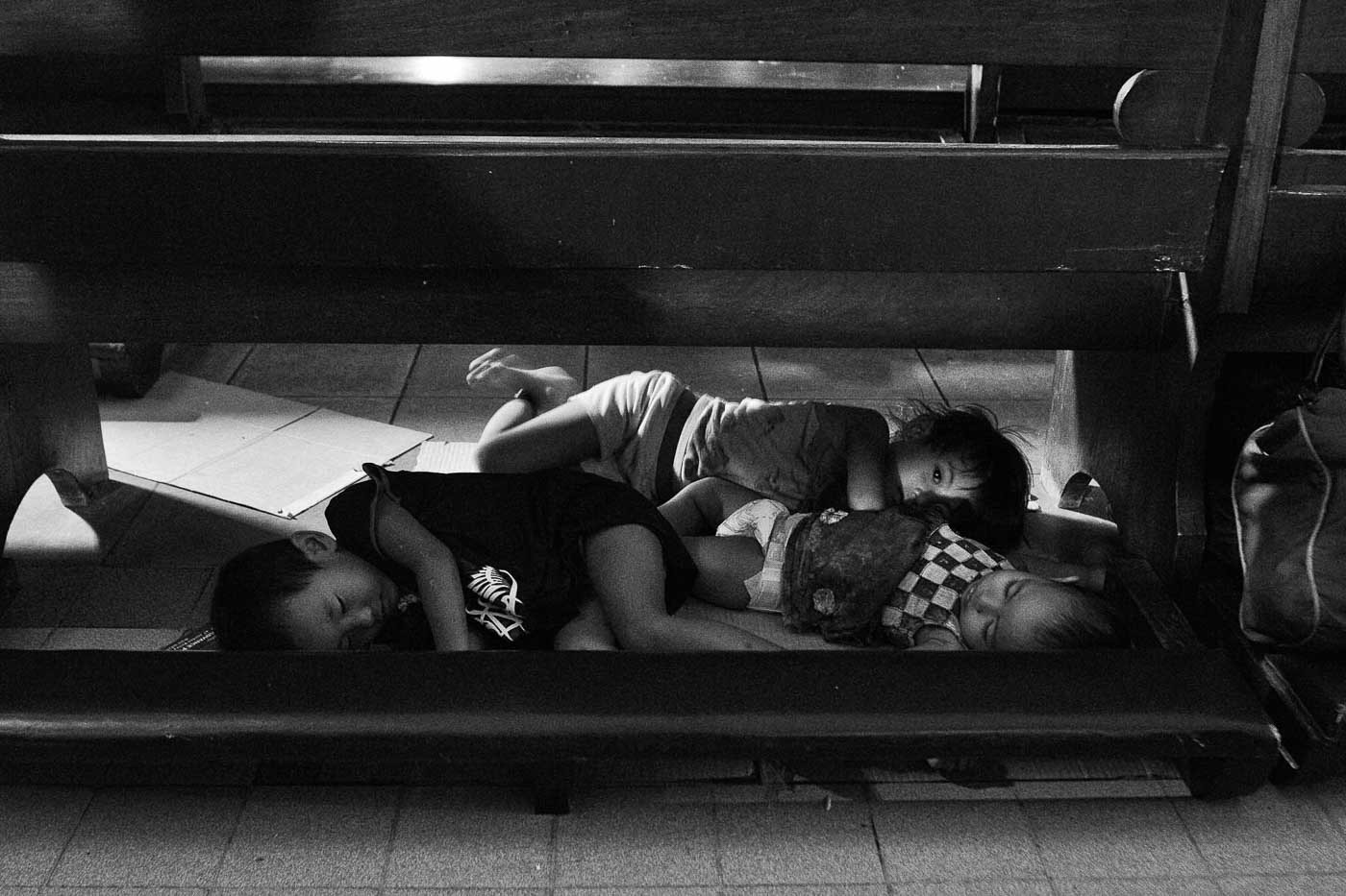 NOWHERE ELSE. Children sleep under pews of the Santo Domingo church after heavy monsoon rains pour over Quezon City and Manila in 2012. 