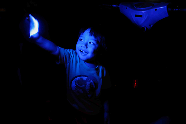 EARTH HOUR IN MANILA. A boy plays with available light from an amusement park ride during Earth Hour in Pasay City, Philippines, 19 March 2016. Mark R. Cristino/EPA  