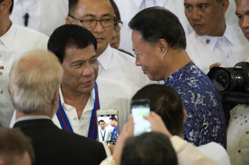 IMPROVING TIES. Philippine President Rodrigo Duterte (left) talks with Chinese Ambassador to the Philippines Zhao Jianhua (right) during the 115th Police Service Anniversary at the PNP headquarters in Manila on August 17, 2016. Photo by Noel Celis/AFP  
