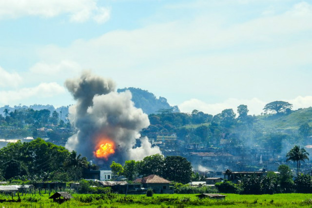 MARAWI CRISIS. Smoke billows from houses after aerial bombings by Philippine Air Force planes on terrorist positions in Marawi City on September 17, 2017. Photo by Ferdinandh Cabrera/AFP 