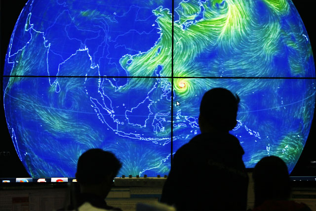 WEATHER WATCH. A man monitors a screen at the PAGASA weather center. Photo by Ben Nabong/Rappler