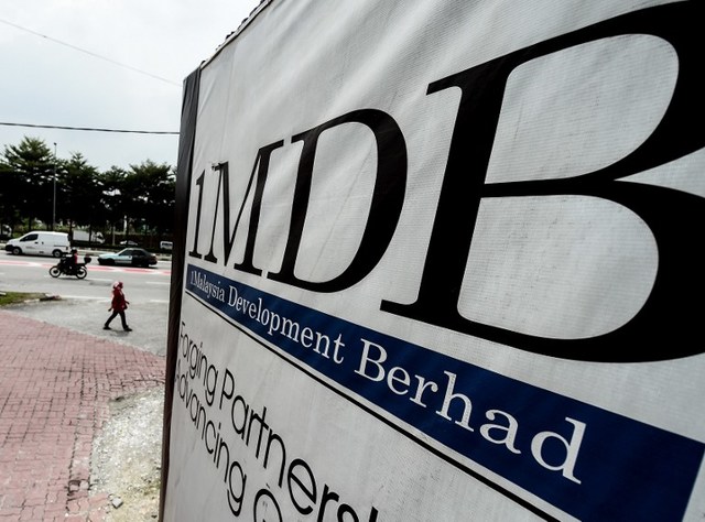 1MDB SCANDAL. This file photo taken on September 22, 2015 shows a Malaysian woman walking past a billboard with the 1 Malaysia Development Berhad (1MDB) logo at the funds flagship Tun Razak Exchange construction site in Kuala Lumpur. File photo by Manan Vatsyayana/AFP 