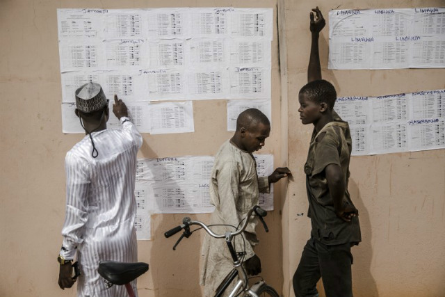 POSTPONED. People check their names in voting lists at the State INEC Independent Electoral Comission Office in Jimeta on February 16, 2019. File photo by Luis Tato/AFP 