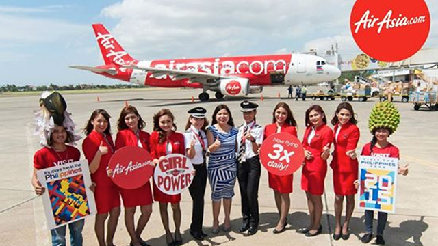 WOMEN POWER. The all-women flight and cabin crew of AirAsia Manila-Davao flight in March 2015 (5th from left): Captain Giselle Bendong, AirAsia Philippines CEO Joy Caneba, and First Officer Iya Halaguena with AirAsia cabin crew and Davao’s Department of Tourism dancers. File photo from AirAsia's Facebook page  
