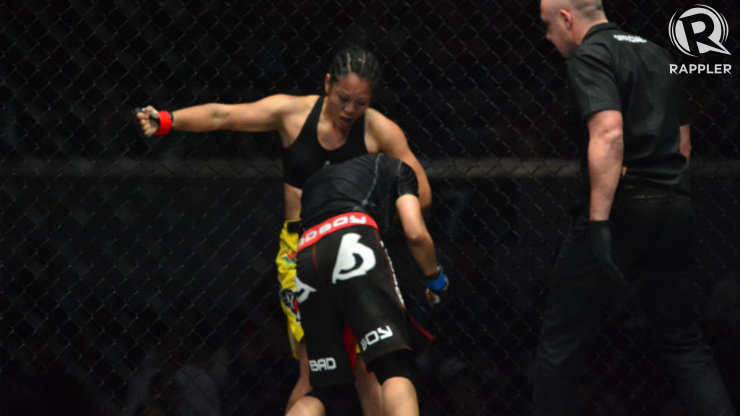 Ana Julaton holds Aya Saber in a headlock while preparing to punch her in the ribs. Photo by Nevin Reyes/Rappler
