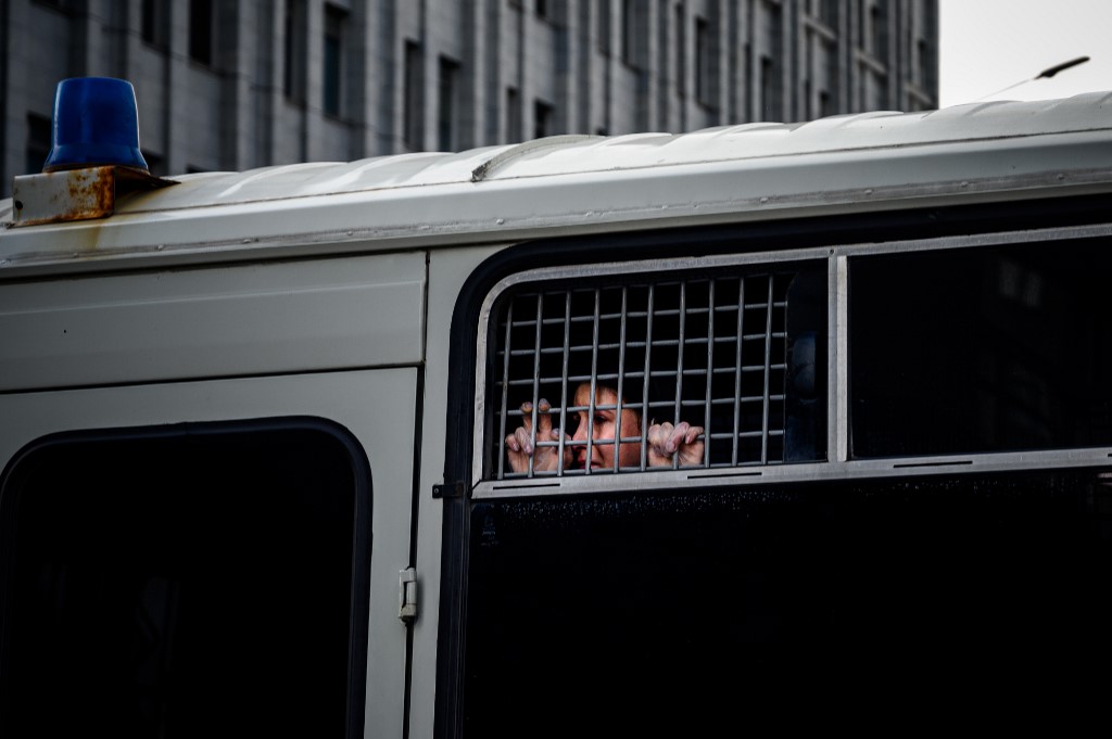 DETAINED. A detained supporter of Ivan Safronov, a former journalist and aide to the head of Russia's space agency Roscosmos, looks out from inside a police bus in central Moscow on July 7, 2020. Photo by Dimitar Diulkoff/AFP  
