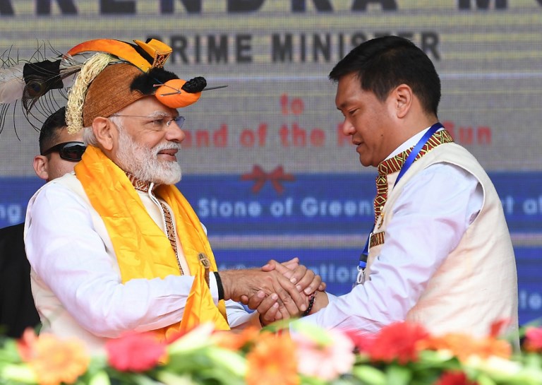 VISIT. This handout photograph released by India's Press Information Bureau (PIB) on February 9, 2019 shows Indian Prime Minister Narendra Modi shaking hands with Arunachal Pradesh chief minister Pema Khandu (R) at the inauguration ceremony for development projects in Itanagar in northeastern Arunachal Pradesh state. Handout/PIB/AFP 