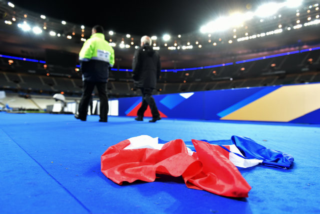 A French national flag lays on the ground in the stadium after the international friendly football match between France and Germany at Stade de Fance in Paris. Dozens of people have been killed in a series of attacks, which included explosions outside the stadium on Friday, November 13. Photo by UWE ANSPACH/EPA 