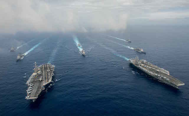 FULL FORCE. The Nimitz-class aircraft carriers USS John C. Stennis (CVN 74), left, and USS Ronald Reagan (CVN 76) conduct dual aircraft carrier strike group operations in the US 7th Fleet area of operations in support of security and stability in the Indo-Asia-Pacific. US Navy photo by Mass Communication Specialist 3rd Class Jake Greenberg  