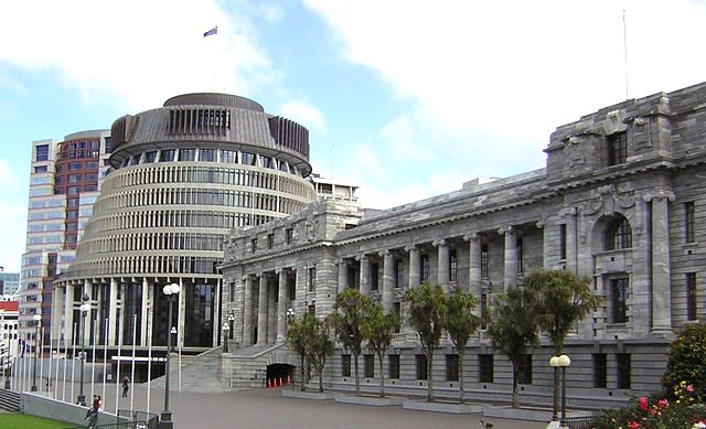 NEW ZEALAND PARLIAMENT. New Zealand's Parliament House (middle and right) and the Beehive (rear left) in Wellington. Photo by Midnighttonight/Wikimedia Commons  